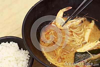 Hot noodles with shrimps top view, wooden background, close-up Stock Photo