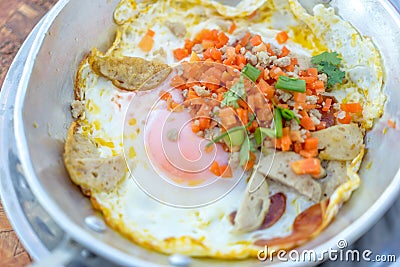 Hot pan fried egg stuff with minced pork and sausage Stock Photo