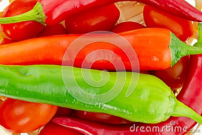 Hot pepper red green closeup on a background of red tomatoes chili sauce background culinary design Stock Photo