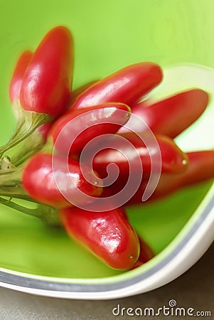 Hot peppers in a green cup Stock Photo