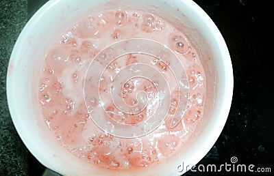 Hot pot boiling sweet strawberry for make jam Stock Photo