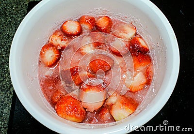 Hot pot boiling sweet strawberry for make jam Stock Photo