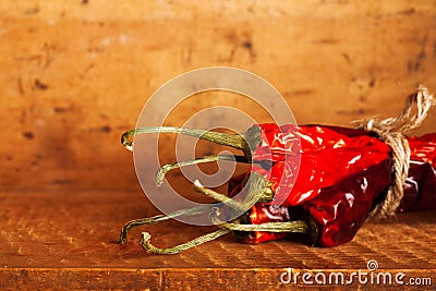 Hot red chillies paper bunch inside wooden case Stock Photo