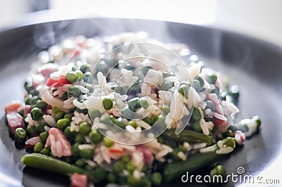 Hot rice with peas, vegetables and bacon, risotto Stock Photo