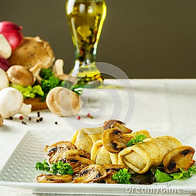 Hot Russian pancakes or blini with mushrooms. Stock Photo