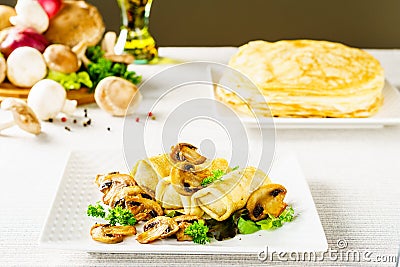 Hot Russian pancakes or blini with mushrooms. Stock Photo