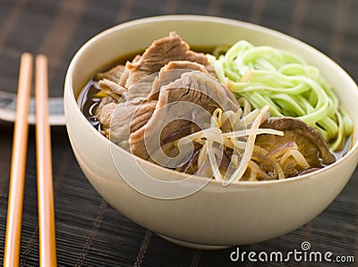 Hot and Sour Beef Broth With Spinach Ramen Noodles Stock Photo