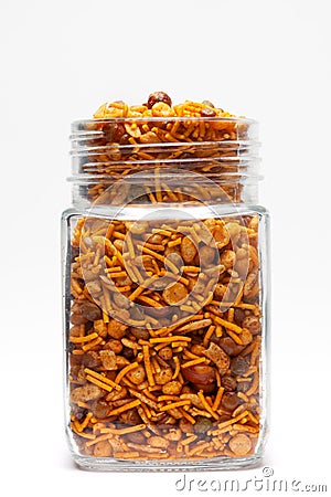 Hot spicy Nav Ratan snacks in a glass jar, made with red chili, peanuts, corn flakes Stock Photo