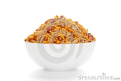 Hot spicy Nav Ratan snacks in a white Ceramic bowl, made with red chili, peanuts, corn flakes Stock Photo