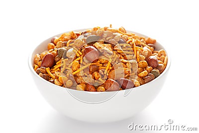 Hot spicy Nav Ratan snacks in a white ceramic bowl made with red chili peanuts Stock Photo