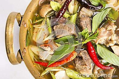 Pork rips hot and spicy soup serve in brass pan isolated Stock Photo