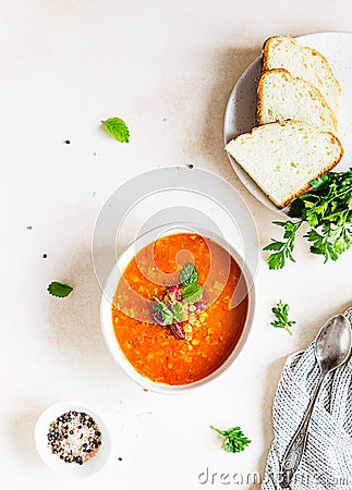 Hot and spicy, thick lentil and red bean soup with canned tomatoes and coriander. Concrete background. Top view Stock Photo