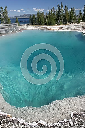 A Hot Spring Adjacent to a Lake with Kayakers, Yellowstone National Park Stock Photo