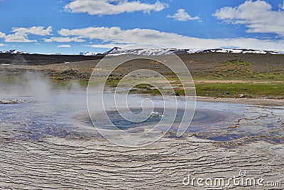 Hot steam coming from the boiling water in the central Iceland in the geothermal area of Hveravellir Stock Photo
