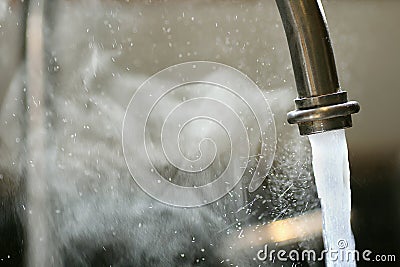 Hot Steaming Water Running from Kitchen Faucet Stock Photo