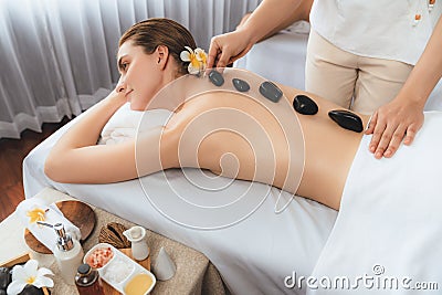 Hot stone massage at spa salon in luxury resort. Quiescent Stock Photo