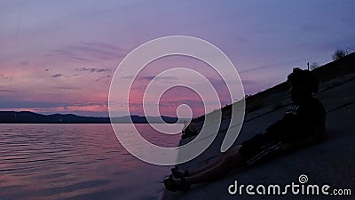 Hot sunset above the forest. Refelctions of red clouds in the water of the lake. bright colors at the end of a summer day Stock Photo