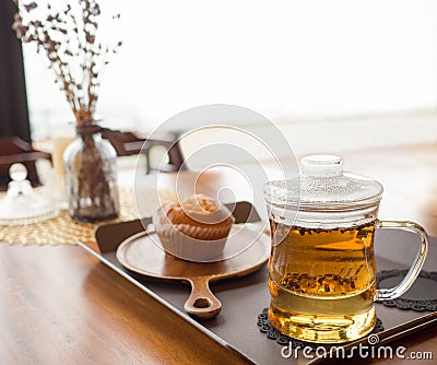 Hot tea in glass cup with bakery cake on table and white light background Stock Photo