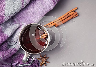 Hot tea or mulled wine in stainless steel cup and checkered plaid on the grey background Stock Photo