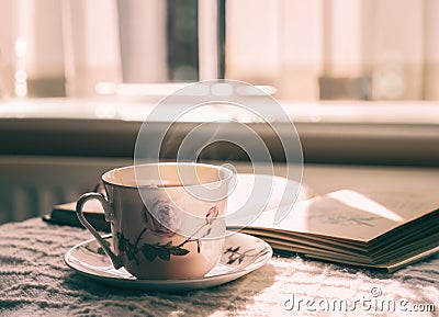 Hot tea with steaming in cinematic tone, Still life cuppa tea with steam on a coffee table with morning light shining from window, Stock Photo