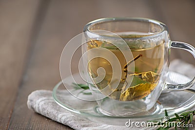 hot tea on wood table. Transparent cup of freshly brewed tea on wood table Stock Photo