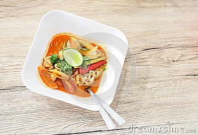 Hot Tom Yum Noodles on Vintage Wooden Background Stock Photo