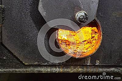Hot water boiler with open door and fire inside and scoop with coal Stock Photo