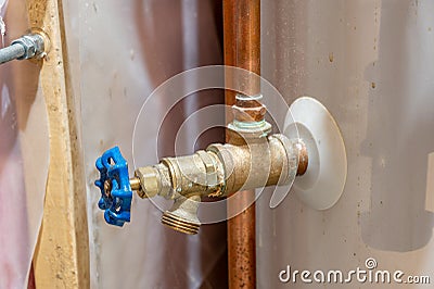 Hot water heater bottom drain valve used for annual maintenance to remove water. Stock Photo