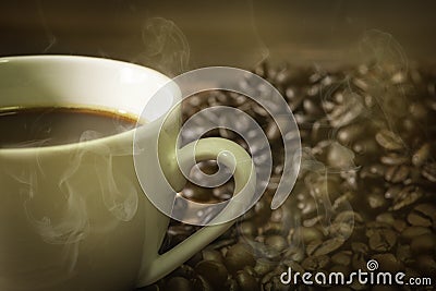 Hot white cup of fresh coffee, cappuccino with Golden fragrant smoke. Stock Photo