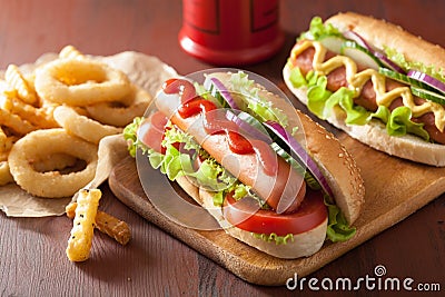 Hotdog with ketchup mustard vegetables and french fries Stock Photo