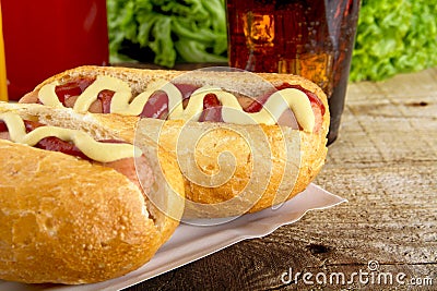 Hotdogs in the tray with ketchup with cola,lettuce on the wooden plank Stock Photo