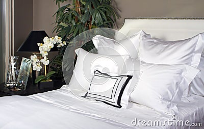 Hotel Bed And White Linen Stock Photo