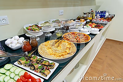 Hotel breakfast board in a family hotel. Buffet with different dishes. Stock Photo