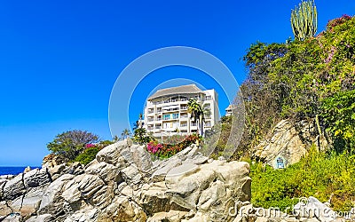 Hotel Condos Apartments on rocky cliff by sea and nature Editorial Stock Photo