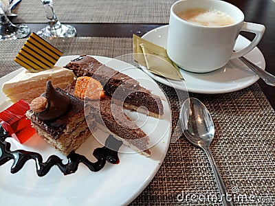 Hotel dessert plate with cakes, tarts and jelly served with tea. Stock Photo