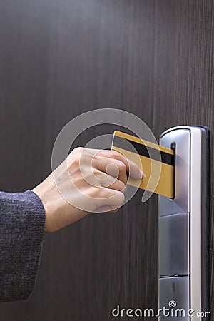 Hotel door - woman& x27;s hand inserting a magnetic stripe hotel key Stock Photo