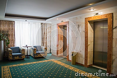 Hotel interior. Furniture and elevators in the hallway Stock Photo
