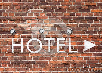 Hotel letters on a brick wall with arrow Stock Photo