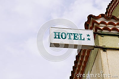 Hotel light sign green text and two stars on Building in tourist city Stock Photo