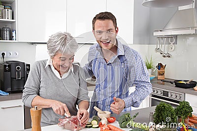 https://thumbs.dreamstime.com/x/hotel-mama-young-man-older-woman-cooking-together-pork-men-women-roast-41976595.jpg