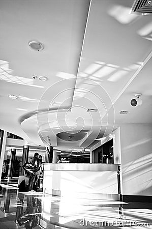 Hotel reception desk with two people checking in Editorial Stock Photo