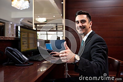 Hotel receptionist being happy with his job Stock Photo