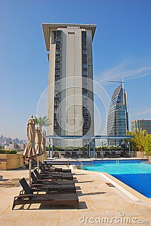 Hotel Rooftop Swimming Pool with deckchair Stock Photo