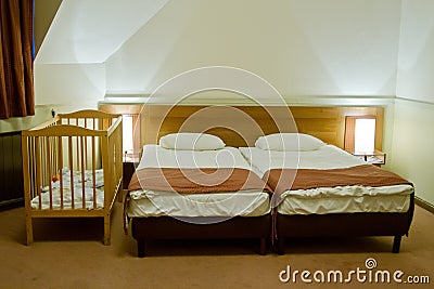 Hotel room with baby cot Stock Photo