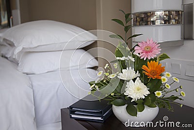 Hotel room with bed and flowers Stock Photo