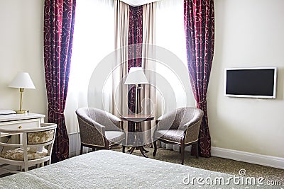 Hotel room in calm colours, sitting area, armchairs and window Stock Photo