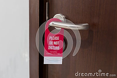 The hotel room with DO NOT DISTURB sign on the door. Stock Photo