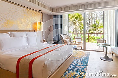 Hotel room in luxury modern resort with tropical palm trees view from window. Luxurious beach hotel for summer holiday Stock Photo