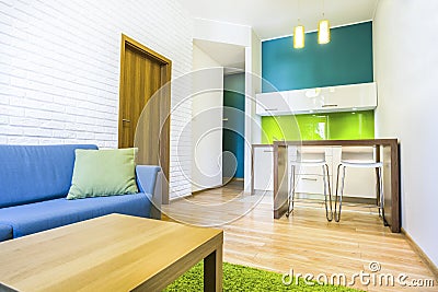 Hotel room with sofa and kitchenette Stock Photo