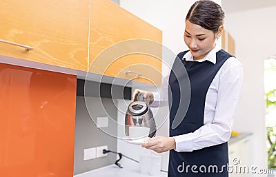 Hotel service concept. Chambermaid holding tray with cup of coffee Stock Photo